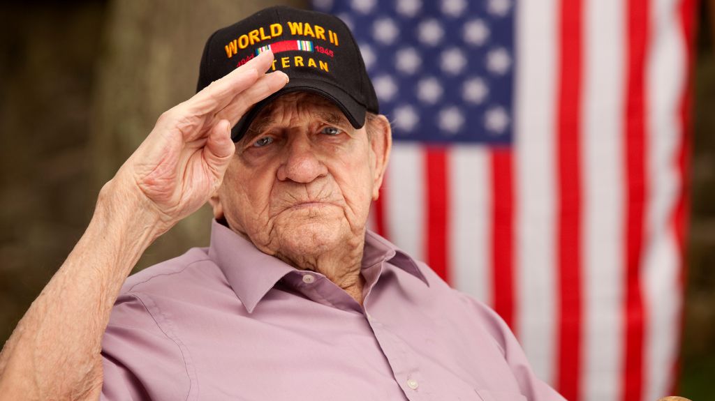 World War II Veteran Saluting in Front of an American Flag