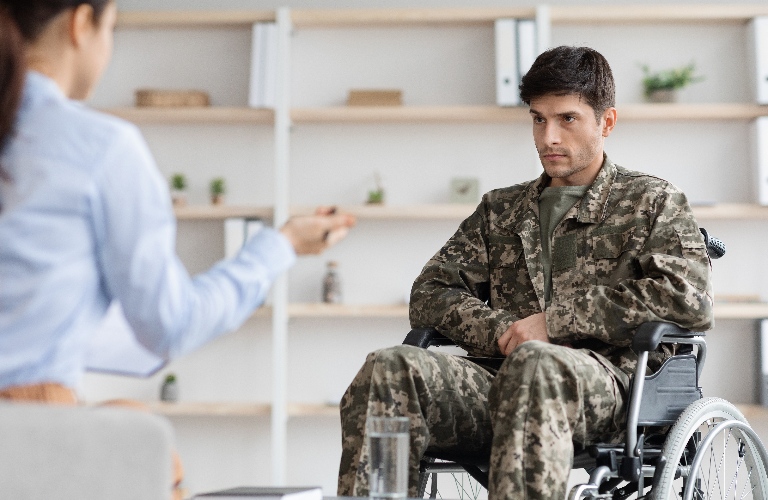 veteran in wheelchair is visiting female lawyer