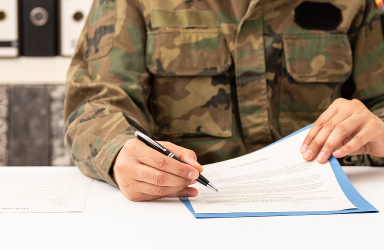 Close up of executive military man hands signing contract