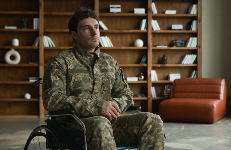Sad pensive depressed young Caucasian male military officer veteran warrior man with disability